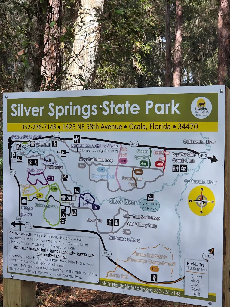Silver Springs State Park trail map sign showing the Sandhill Loop, Swamp Trail, Flatwoods Loop, and connections to the Florida National Scenic Trail.
